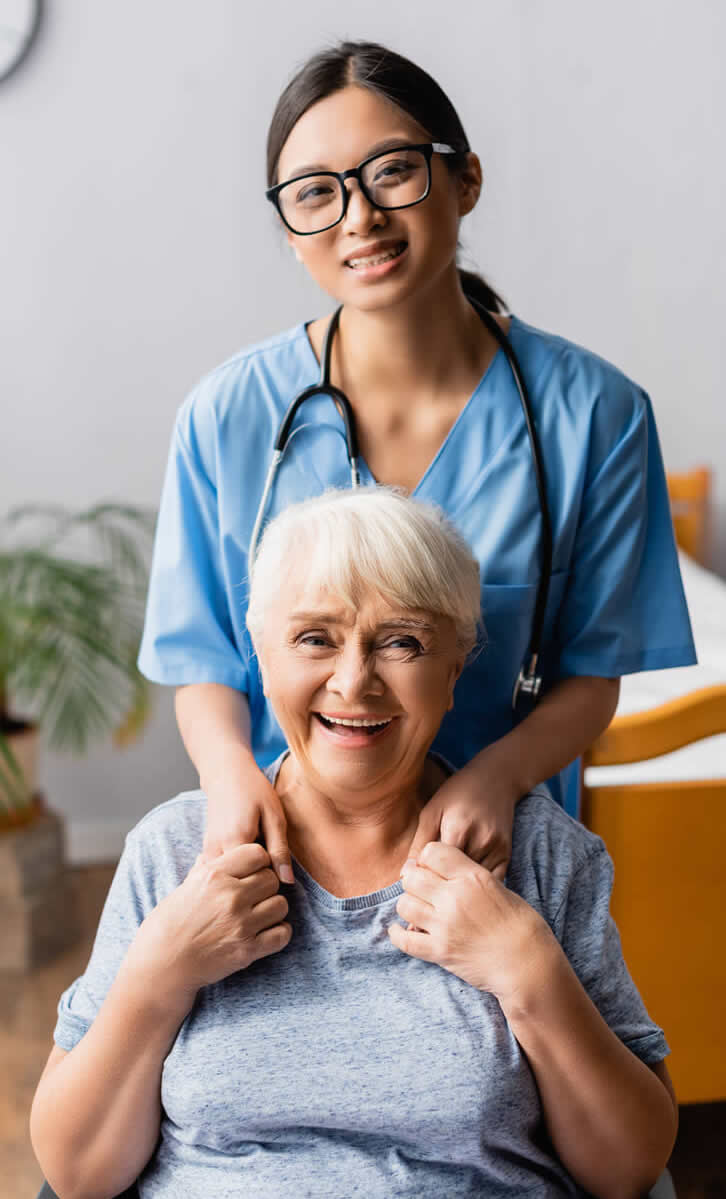 Nurse standing behind a patient in a wheelchair